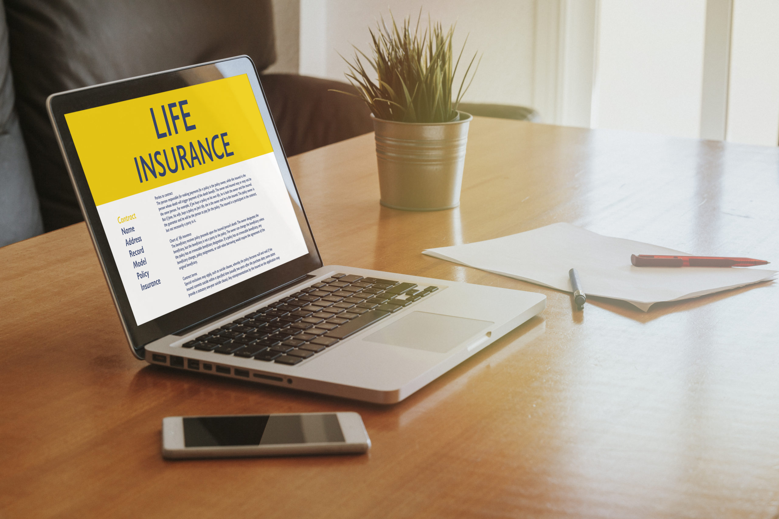 Laptop displaying various life insurance policy options on its screen.